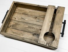 an old wooden tray with a hole in it