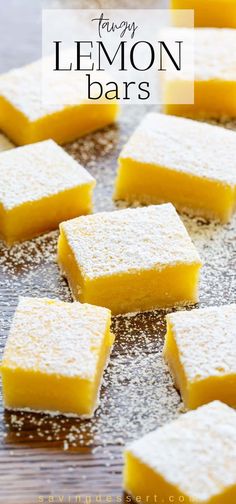 lemon bars on a baking sheet with powdered sugar