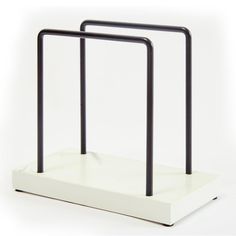 a pair of black and white metal stands on a white surface, with one standing upright