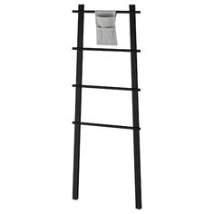 a black ladder with a toilet paper holder on it's side and a roll of toilet paper hanging from the top