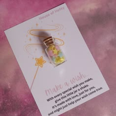 a card with a message inside it and a glass bottle filled with gummy bears