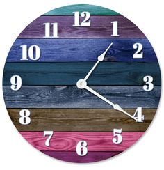 a clock made out of wood with numbers on the front and side of it, painted in different colors