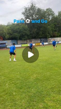 some people in blue shirts are playing soccer on the grass and one person is holding a ball