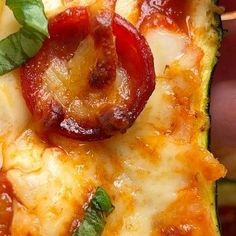 a close up of a pizza with cheese and toppings on it, including pepperoni