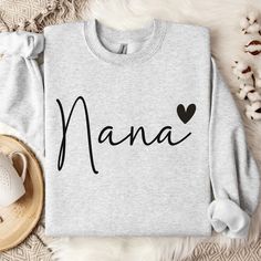 Introducing our newest Nana  Sweatshirt--a stylish and comfortable garment designed for those who understand the power of positive influence. Crafted with premium cotton blend, this cozy sweatshirt not only offers warmth but also makes a bold statement. Elevate your style while spreading a powerful message with this unique and meaningful piece. The collar is ribbed knit, so it retains its shape even after washing. There are no itchy side seams on these sweatershirts. Nice for chilly evenings and colder days, this sweatshirt will be a staple all season. For oversized style/look - please size up. See size chart for reference. Due to monitor settings and lighting, colors may appear slightly different. More about this sweatshirt: - 50% cotton, 50% polyester - Medium-weight fabric (8.0 oz/yd² ( Nana Sweatshirt Ideas, Nana Sweater, Nana Sweatshirt, Shirts Embroidery, New Grandma Gift, Sweatshirt Ideas, Nana Shirts, Positive Influence, New Grandma