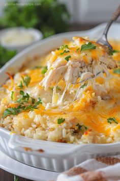 a casserole dish filled with chicken and rice, garnished with parsley