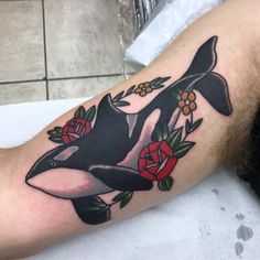 an orca whale with roses on his arm is seen in this tattoo photo taken by the owner