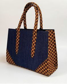 African print handbag Statement handbag with Jean Hand-crafted using African print fabric Size: 14 by 10 by 4.5 African Fabric Accessories, Ankara Bags, Modern Handbag, Handmade Fabric Bags, Statement Handbag, African Bag, Hand Bags For Women, African Accessories, Diy Bag Designs