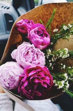 a bouquet of flowers sitting on top of a car seat