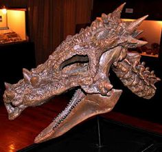 a bronze dragon head on display in a museum