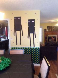 a dining room table with black cloths on it and two paper cut out figures