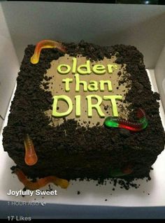 a cake that is in a box with the words older than dirt written on it