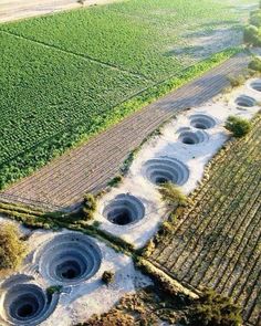 an aerial view of several holes in the ground