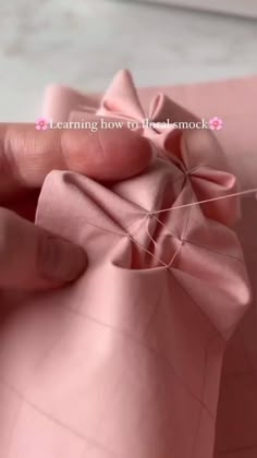 someone is stitching together fabric with scissors