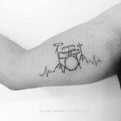 a black and white photo of a drummer's drum set on his arm with heartbeats