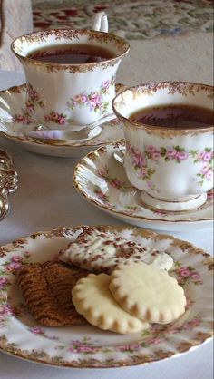 there is a cup of tea and cookies on the table