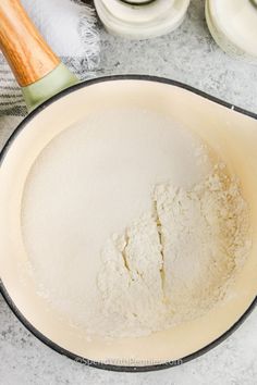 a pan filled with flour next to other ingredients