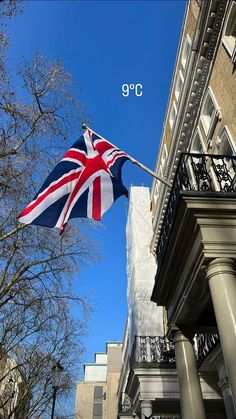 a british flag flying in front of a building