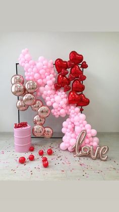 balloons and confetti are arranged in the shape of letters that spell out love