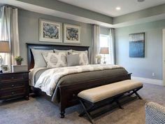 a bedroom with gray walls and carpeted flooring