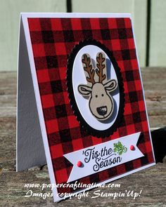 a close up of a card with a deer on it's head and plaid background