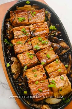 tofu with mushrooms and green onions in a skillet