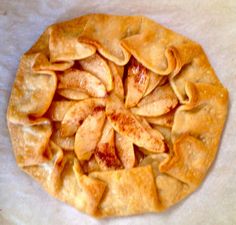 an apple pie is shown on a white surface