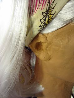 a wig with white hair is being worked on by a mannequin's head