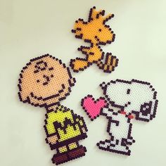 three beaded cartoon characters on a white surface