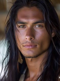 a man with long black hair and blue eyes