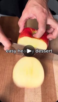 a person cutting an apple with a knife