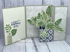 two cards with green leaves and blue vases