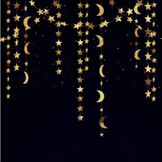 stars and crescents hanging from strings in the night sky with moon's on them