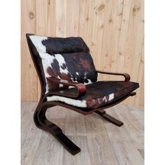 the chair is made out of wood and cowhide