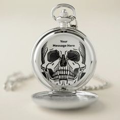 a skull shaped pocket watch with the words your message here on it's face