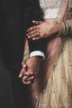 the bride and groom are holding hands