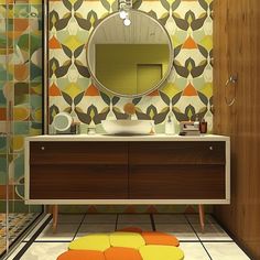 a bathroom with a mirror, sink and colorful tiles on the wall next to it