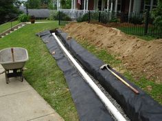 an image of a yard being worked on by someone with a wheelbarrow and shovel