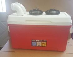 a red and white cooler sitting on top of a table