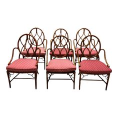 four chairs with pink upholstered cushions