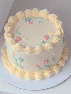 there is a white cake with flowers on it