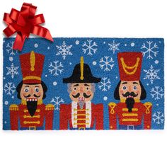 a blue door mat with three nutcrackers on it and a red bow