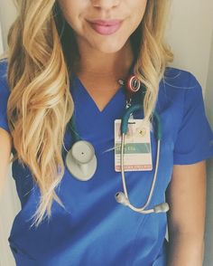 a woman wearing a blue scrub top and stethoscope