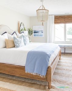 a bedroom with a large bed and white walls