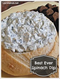 the best ever spinach dip recipe is on a plate with crackers and bread