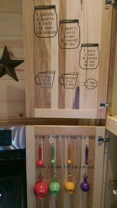 two wooden shelves with cups and spoons on them in a kitchen next to an oven