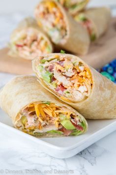 chicken and cheese burritos on a white plate