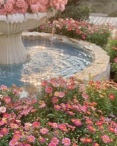 a fountain filled with lots of pink flowers