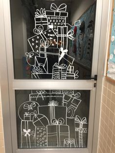 a drawing on the glass door of a store with presents and gifts drawn on it