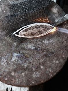 a knife is being used to cut something on a table with some kind of wire